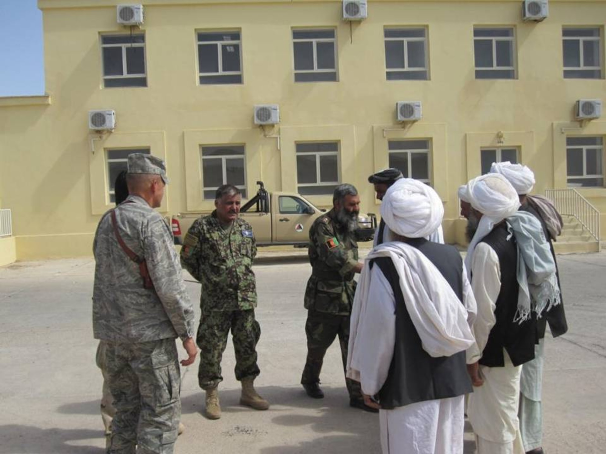 SHINDAND, Afghanistan - The 838th Air Expeditionary Advisory Group Commander, Colonel Larry Bowers and Afghan Air Force Colonel Shoresh meet with Deh Ali Baig village elders to discuss ways the Afghan National Security Forces and Coalition partners can assists their civilian neighbors on Aug. 5, 2010.