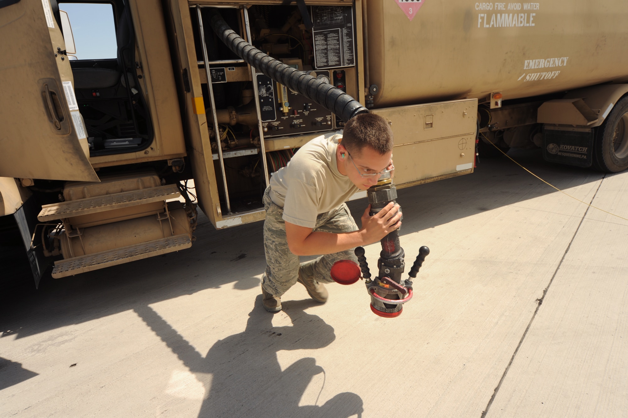 TRANSIT CENTER AT MANAS, Kyrgyzstan - Airman 1st Class Bryan Stevens, 376th Logistics Readiness Squadron, pulls the fuel hose to fuel a Boeing 767 before it departs with soldiers returning home Aug. 3. He is one of about 40 Airmen who pump more than 320,000 gallons of fuel a day at the Transit Center. (U.S. Air Force photo/Staff Sgt. Nathan Bevier)
