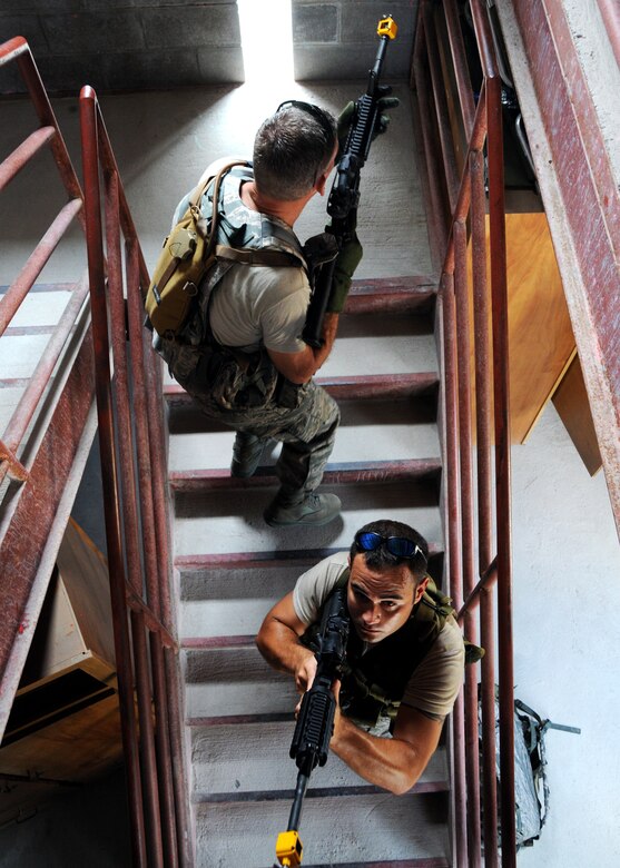 (Top to bottom) Staff Sgt. William Messer and Tech. Sgt. John Glenister, 919th Security Forces Squadron, advance up a staircase during room-clearing training at Eglin Air Force Base Fla.  SFS teams practiced entry and clearing tactics and procedures with varying targets, objectives and ammunition Aug. 7.  Blanks and simulated munitions were used to create a more realistic scenario for the Reservists from Duke Field.  (U.S. Air Force photo/Tech. Sgt. Samuel King Jr.)