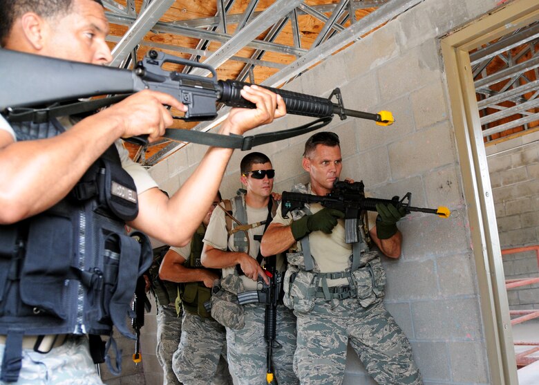 Tech. Sgt. John McDowell, 919th Security Forces Squadron, gives the clearance for his fire team to exit the room during room-clearing training at Eglin Air Force Base Fla.  SFS teams practiced entry and clearing tactics and procedures with varying targets, objectives and ammunition Aug. 7.  Blanks and simulated munitions were used to create a more realistic scenario for the Reservists from Duke Field.  (U.S. Air Force photo/Tech. Sgt. Samuel King Jr.)