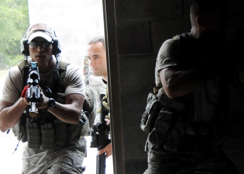 Senior Airman Gabriel Ortiz, 919th Security Forces Squadron, is the second man in during room clearing training at Eglin Air Force Base Fla.  SFS teams practiced entry and clearing tactics and procedures with varying targets, objectives and ammunition Aug. 7.  Blanks and simulated munitions were used to create a more realistic scenario for the Reservists from Duke Field.  (U.S. Air Force photo/Tech. Sgt. Samuel King Jr.)