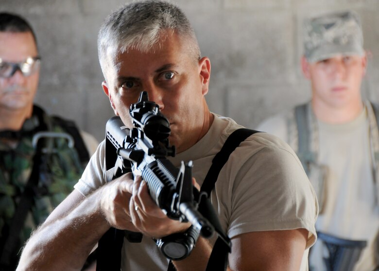 Senior Master Sgt. Ronald McCulley, 919th Security Forces Squadron, demonstrates the proper technique while others watch during room-clearing training at Eglin Air Force Base Fla.  SFS teams practiced entry and clearing tactics and procedures with varying targets, objectives and ammunition Aug. 7.  Blanks and simulated munitions were used to create a more realistic scenario for the Reservists from Duke Field.  (U.S. Air Force photo/Tech. Sgt. Samuel King Jr.)