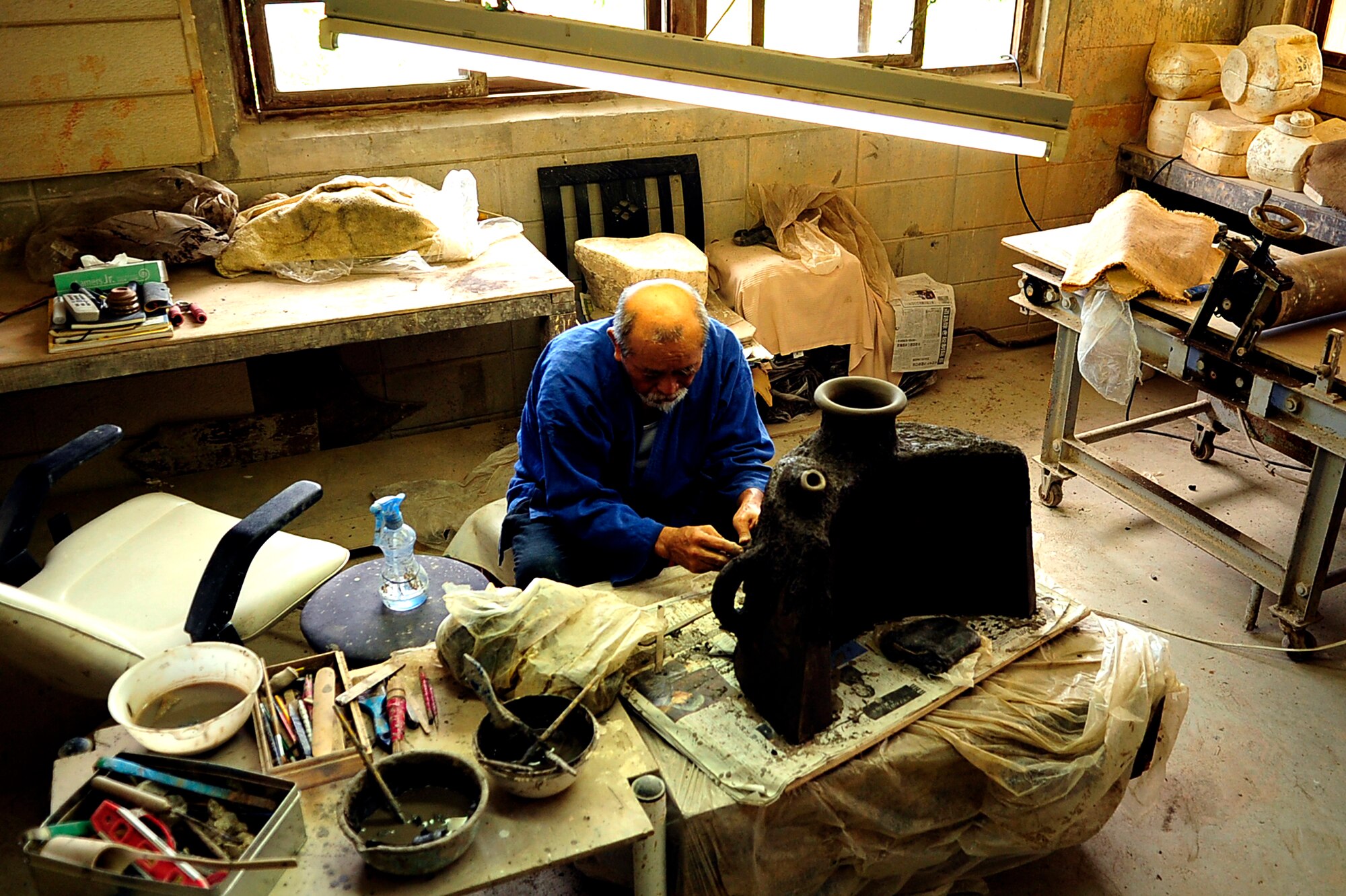 Mr. Hideo Miyagi, a famous Okinawan Potter, manipulates soft clay into a traditional Okinawan vase at his shop in the Chibana district of Okinawa on July 15, 2010. (U.S. Air Force photo/Senior Airman Amanda Grabiec)


