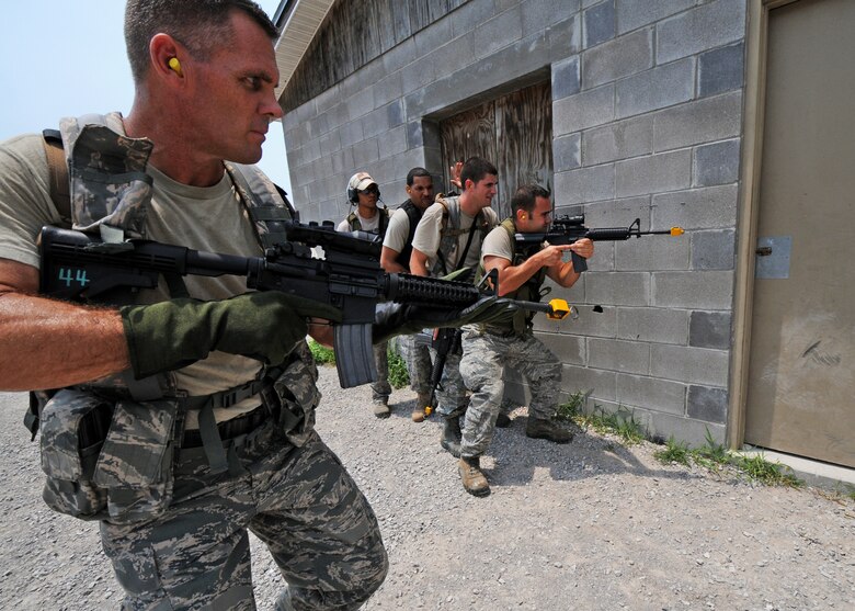 Staff Sgt. William Messer, 919th Security Forces Squadron, moves into position to open the door for his fire team during room-clearing training at Eglin Air Force Base Fla. SFS teams practiced entry and clearing tactics and procedures with varying targets, objectives and ammunition Aug 7.  Blanks and simulated munitions were used to create a more realistic scenario for the Reservists from Duke Field.  (U.S. Air Force photo/Tech. Sgt. Samuel King Jr.)