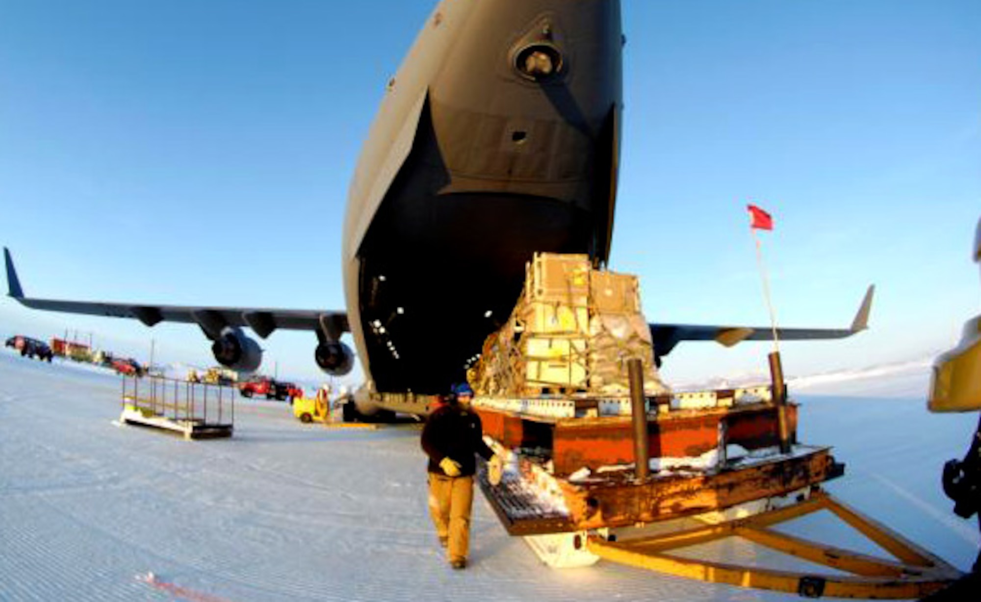 MCMURDO STATION, Antarctica - A loadmaster supervises the movement of a pallet of cargo off Pegausus Runway. Pallets like these typically  contain a variety of equipment and foodstuff, as part of Joint Base Lewis-McChord's mission to support the U.S. Antarctic program and the National Science Foundation, in preparation for Operation Deep Freeze. Both the 62nd and 446th Airlift Wing's at JBLM McChord Field provide the C-17 support for Operation Deep Freeze. This year's WINFLY period, which begins Aug. 9 and is scheduled to last until Aug. 29, will deliver advance teams and cargo for the upcoming main season of ODF. (Courtesy photo/ Chief Master Sgt. James Massura).
