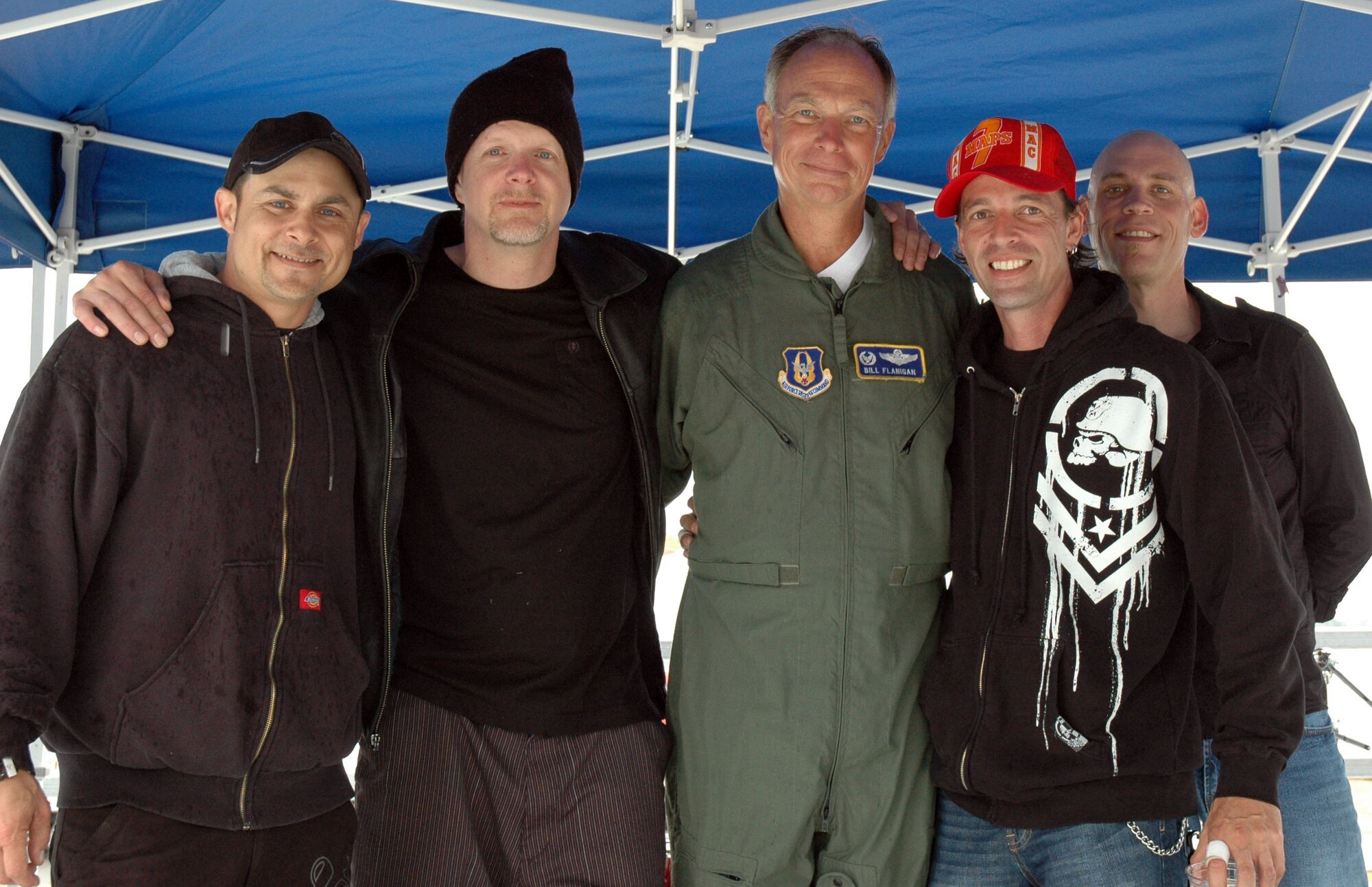 JOINT BASE LEWIS-MCCHORD, Wash., - Col. William Flanigan, 446th Airlift Wing commander, shares the stage with bandmembers from Mom's Rocket.  The band rocked everyone at the annual 446th Airlift Wing Family Day here on Aug. 7. (U.S. Air Force photo/Staff Sgt. Elizabeth Moody)