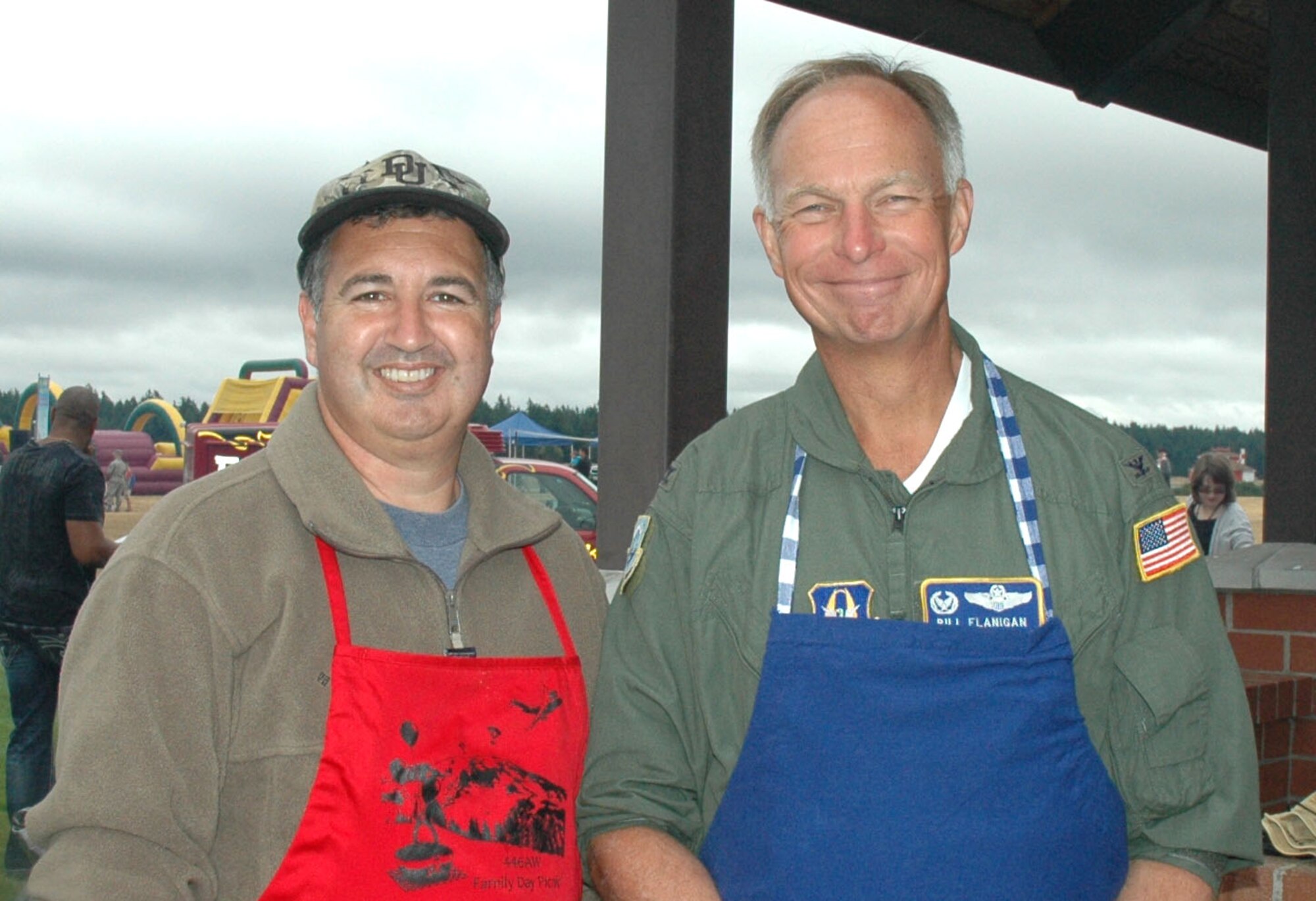 JOINT BASE LEWIS-MCCHORD, Wash., - Lt. Col. Lee Brady, a pilot with the 728th Airlift Squadron and Col. William Flanigan, 446th Airlift Wing commander here, man the grill during the 446th Airlift Wing's annual Family Day Aug. 7.  Hundreds of Reservists and their families enjoyed food, games, and music during the event. (U.S. Air Force photo/Staff Sgt. Elizabeth Moody)
