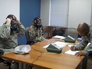 Senior Airman Jeni Nagy, 916th Aerospace Medicine Flight and Staff Sgt. Kenan Blevins, 916th Command Post ensure their gas masks are properly fit tested with 4th Fighter Wing Bioenvironmental Staff Sgt. Theodonte Wiseman. (USAF photo by MSgt. Wendy Lopedote, 916ARW/PA)