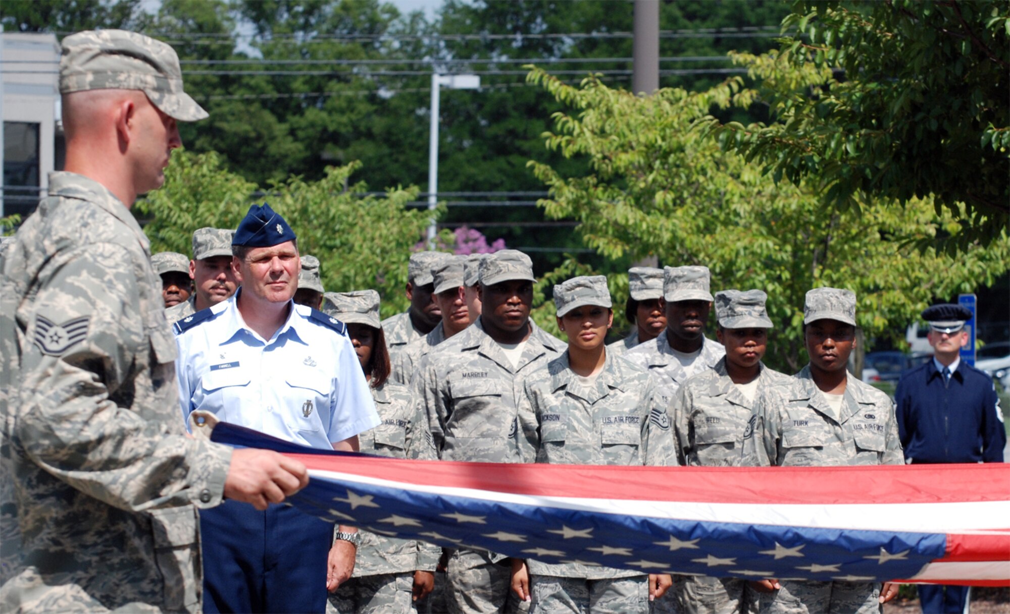The 94th Airlift Wing Logistics Readiness Squadron hosts the retreat ceremony here to signify the end of the official duty day Aug. 7. The 94th LRS pays respect to flag as it is symbolically folded. (U.S. Air Force photo/ Senior Airman Danielle Campbell)