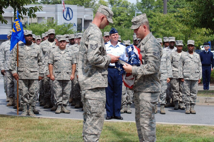 The 94th Airlift Wing Logistics Readiness Squadron hosts the retreat ceremony here to signify the end of the official duty day Aug. 7. The 94th LRS pays respect to flag as it is folded symbolically. (U.S. Air Force photo/ Senior Airman Danielle Campbell)