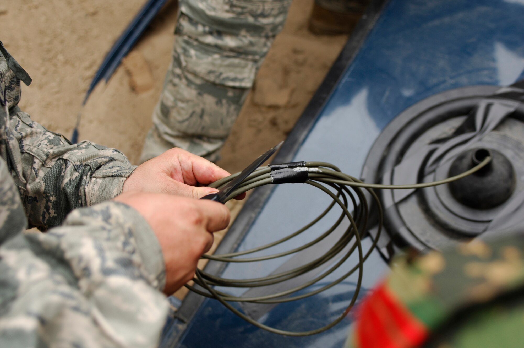 TRANSIT CENTER AT MANAS, Kyrgyzstan ? An EOD instructor prepares an explosive cord in order to blow a hole in a truck door. The objective of this lesson was to show various vehicle disruption techniques. (U.S. Air Force Photo/Tech. Sgt. Jennifer Buzanowski)