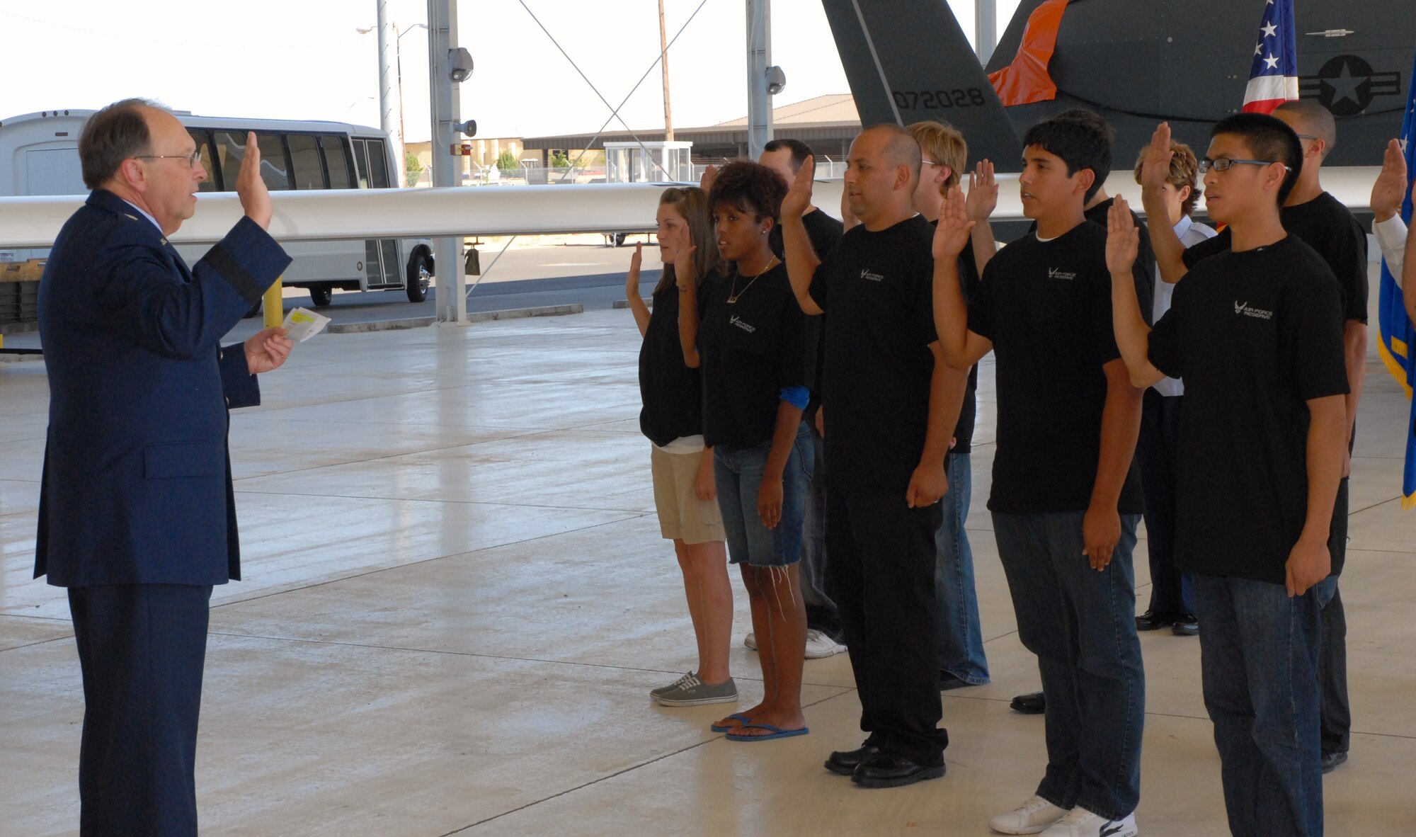 General Stenner administers the enlistment oath to recruits in Dock 8, in July.