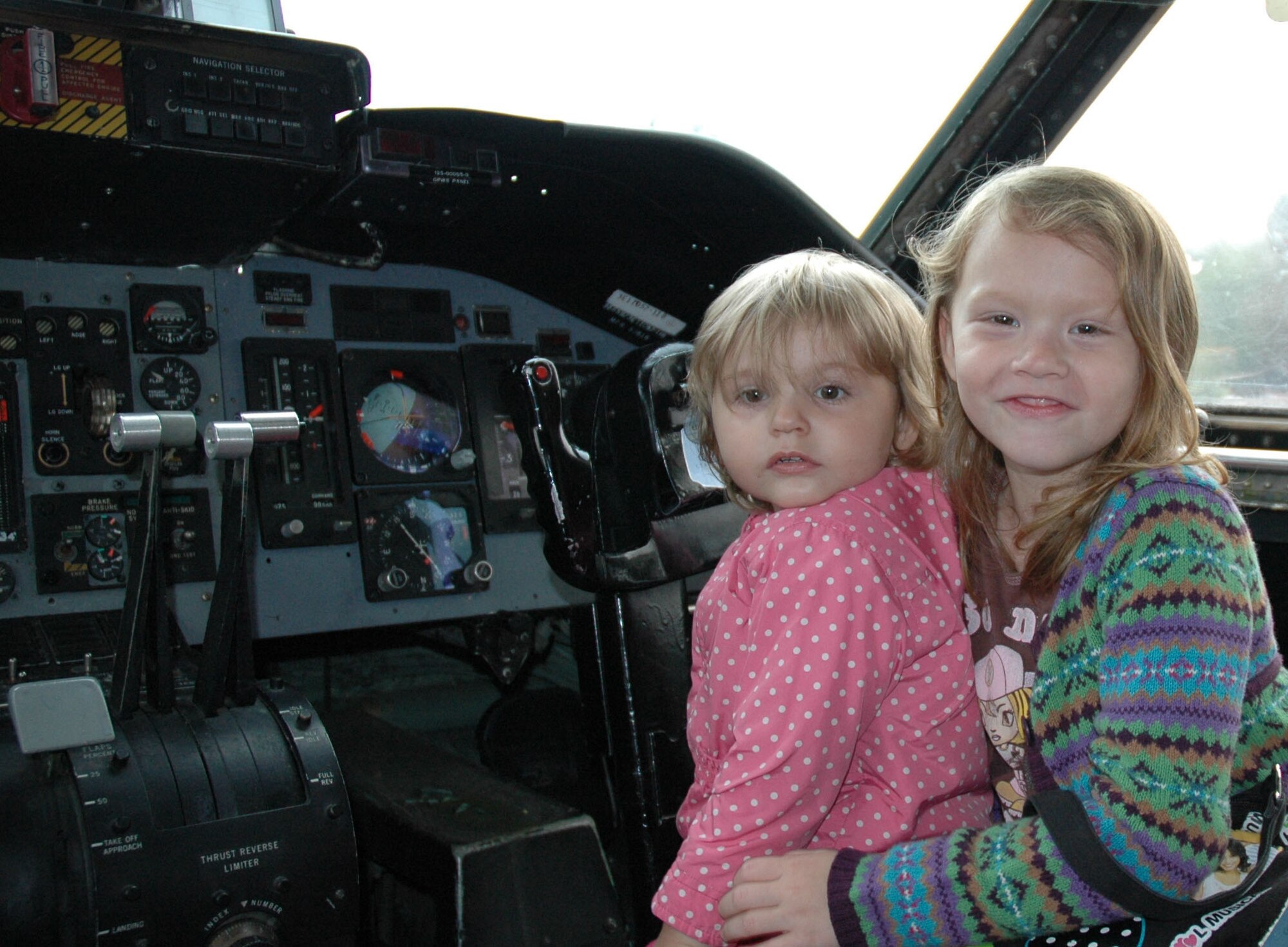 JOINT BASE LEWIS-MCCHORD, Wash., - Emilee Debord, 2, and Julia Debord, 7, are young pilots in training at the 446th Airlift Wing Family Day. The girls shared a seat in the flight deck of the McChord Musuem's C-141B Starlifter on static display, Aug. 7. Both are children of Senior Airman Nathan Debord, 446th Aircraft Maintenance Squadron here. (U.S. Air Force photo/Staff Sgt. Elizabeth Moody).