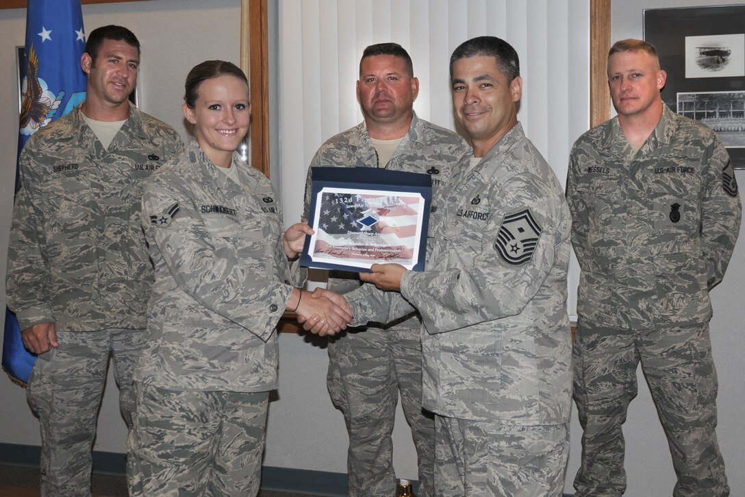 First Sergeants of the 132nd Fighter Wing present Airman 1st Class Jennifer Schwaigert (second from left) with the Diamond Sharp Award at the 132nd Fighter Wing, Des Moines, Iowa, on August 8, 2010.  (US Air Force photo/Staff Sgt. Linda E. Kephart)(Released)