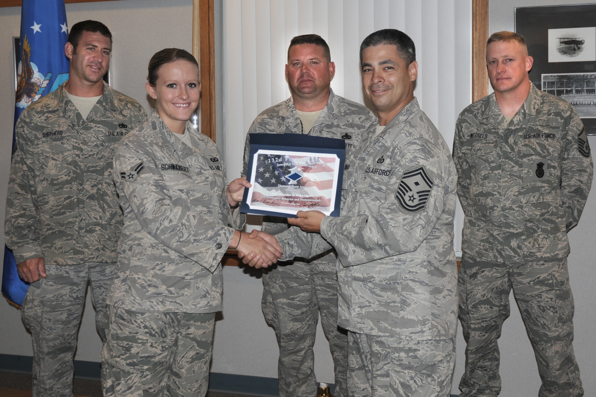 First Sergeants of the 132nd Fighter Wing present Airman 1st Class Jennifer Schwaigert (second from left) with the Diamond Sharp Award at the 132nd Fighter Wing, Des Moines, Iowa, on August 8, 2010.  (US Air Force photo/Staff Sgt. Linda E. Kephart)(Released)