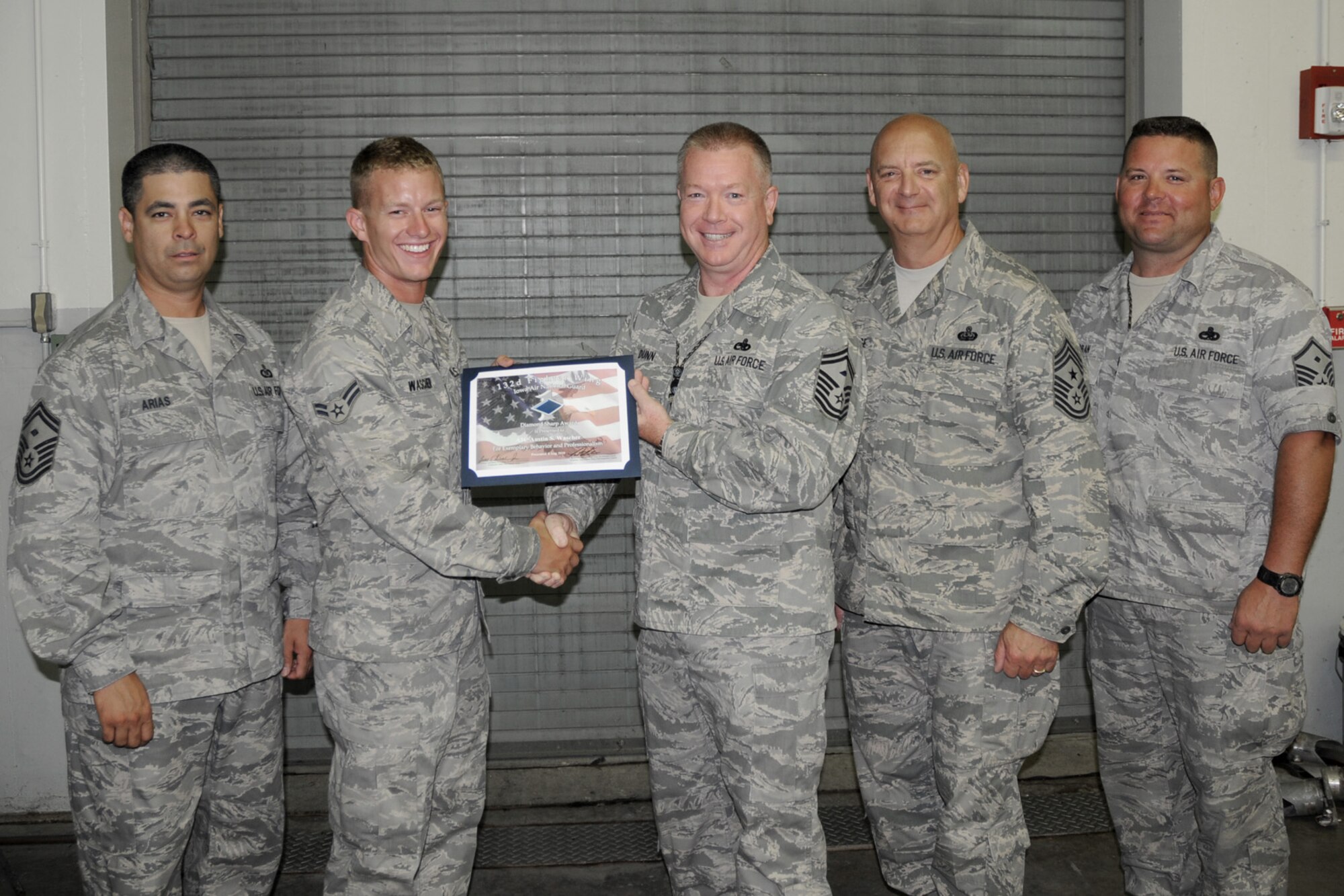 First Sergeants of the 132nd Fighter Wing present Airman 1st Class Austin Wascher (second from left) with the Diamond Sharp Award at the 132nd Fighter Wing, Des Moines, Iowa, on August 8, 2010.  (US Air Force photo/Staff Sgt. Linda E. Kephart)(Released)