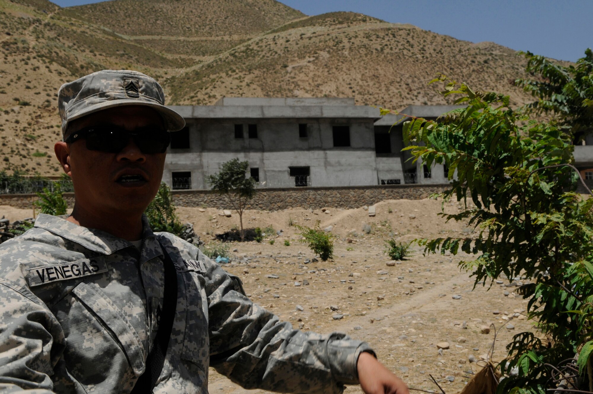 U.S. Army Sgt. 1st Class Remelo Venegas, U.S. Army Corps of Engineers, Contracting Representative, a native of Maui Hawaii, examines the sit of the police station's leach field, which is an environmentally friendly way of getting rid of wastewater in the Khenj District, Panjshir Province.  (Photo by U.S. Air Force Tech. Sgt. Sean M. White, Provincial Reconstruction Team Panjshir) 