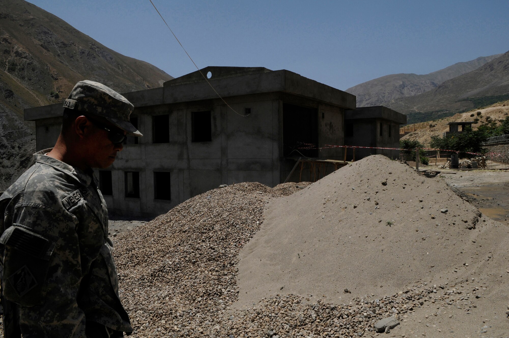 U.S. Army Sgt. 1st Class Remelo Venegas, U.S. Army Corps of Engineers, Contracting Representative, a native of Maui Hawaii, provides quality assurance and quality control of the construction project for a future police station in the Khenj District, Panjshir Province.  When finished the facility will be the police station for 100 policemen.  (Photo by U.S. Air Force Tech. Sgt. Sean M. White, Provincial Reconstruction Team Panjshir) 