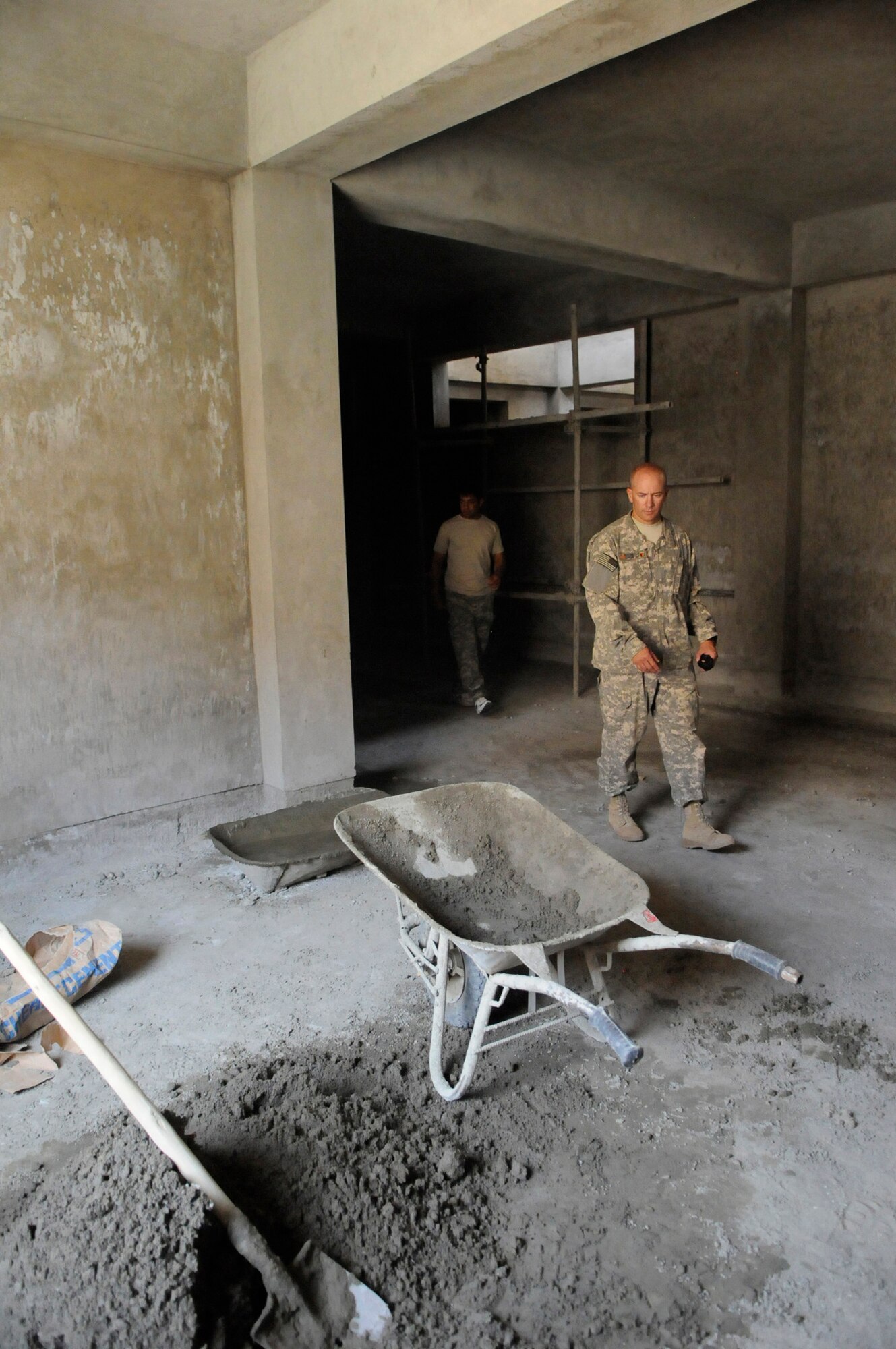 U.S. Army Major Keith Clipp, U.S. Army Corps of Engineers Bagram, resident officer in charge, and Orleans Ill. native, tours the construction site providing on the spot quality assurance and quality control of a future police station in the Khenj District, Panjshir Province.  When finished the facility will be the police work center for 100 policemen.  (Photo by U.S. Air Force Tech. Sgt. Sean M. White, Provincial Reconstruction Team Panjshir) 