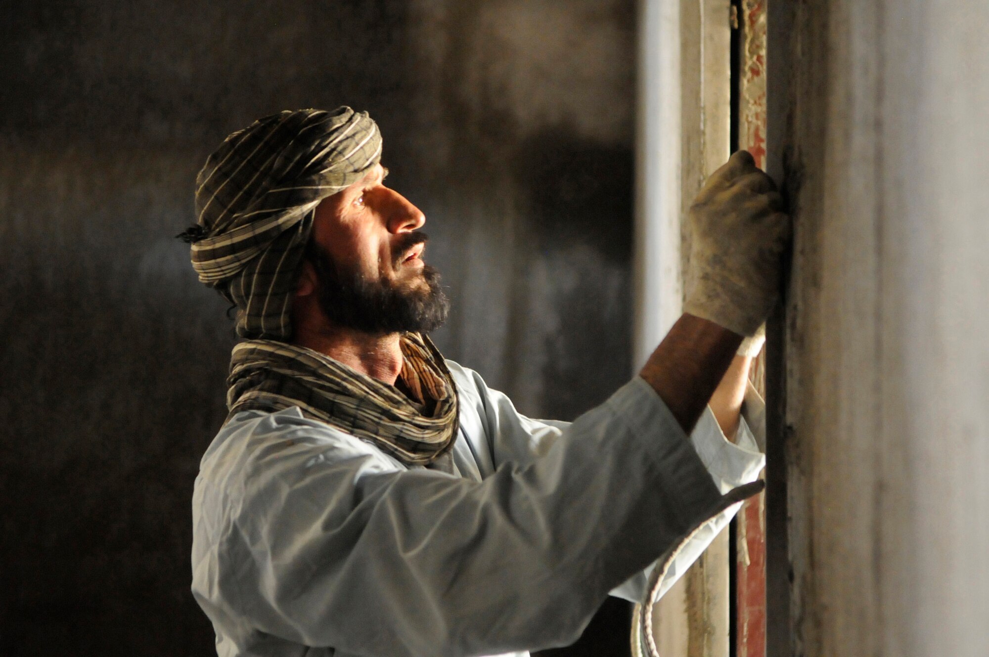 A local contactor meticulously squares a door frame inside the future Afghan National Police station Khenj District, Panjshir Province.  When finished the facility will be the police station for 100 policemen.  (Photo by U.S. Air Force Tech. Sgt. Sean M. White, Provincial Reconstruction Team Panjshir) 