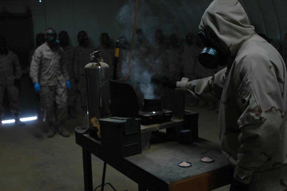 Sgt. Johnny Sermersky, chemical biological radiological nuclear instructor, Weapons Field Training Battalion, Edson Range, Marine Corps Base Camp Pendleton, Calif., burns more chlorobenzylidene malononitrile capsules, also known as CS gas on Aug 9. CS gas is not fatal, but it does cause burning skin, irritation of the nose and throat, coughing, excess mucous and watery eyes.