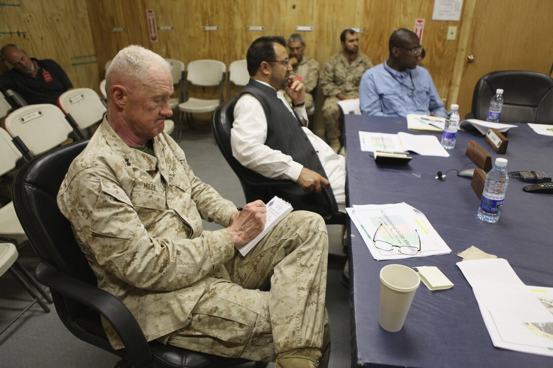 Maj. Gen. Richard P. Mills, commander of Regional Command Southwest, and Helmand Provincial Governor Gulab Mangal listen to a brief during the fifth Afghan Uniformed Police Recruitment Conference, Aug. 9, at Camp Leatherneck, Afghanistan.  The meeting was held in order to discuss the progress being made in increasing the number of Afghan policemen throughout Helmand province.