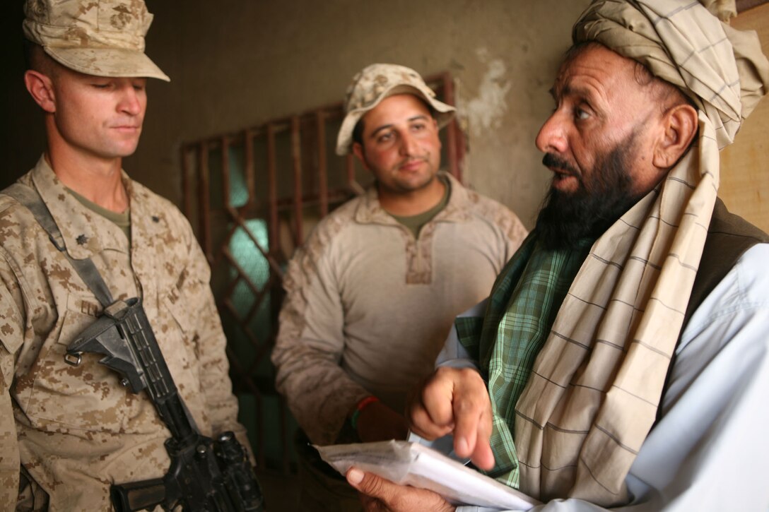 Nazar Khan Taukalyar, the Marjah district education director, discusses plans for a future primary school in Marjah with Lt. Col. Kyle B. Ellison, commanding officer of 2nd Battalion, 6th Marine Regiment, before a ground-breaking ceremony in Marjah, Afghanistan, Aug. 9, 2010.
