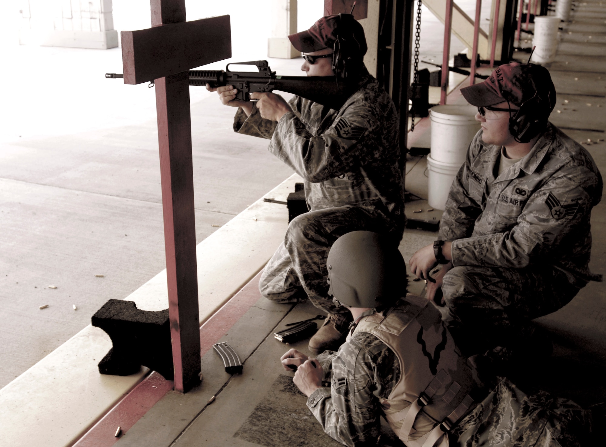 Staff Sgt. Alan McNew  tests sight alignment adjustments on an M16-A2 rifle for Senior Airman Erik Zwolinksi July 8, 2010, at the combat arms training and maintenance shooting range. Sergeant McNew and Airman Zwolinksi 92nd Security Forces combat arms and maintenance instructor, (U.S. Air Force photo/Airman 1st Class Natasha E. Stannard)