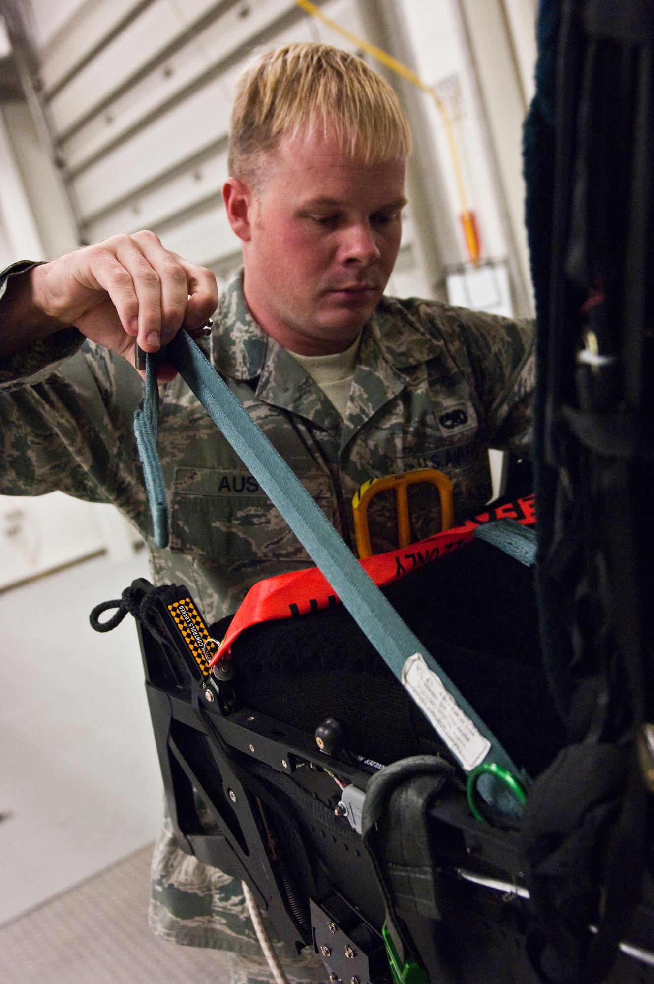 JOINT BASE ELMENDORF-RICHARDSON, Alaska – Senior Airman Jonathan Austin, 3rd Component Maintenance Squadron Egress Flight, looks over an F-15 Eagle ejection seat Aug. 5. The 3rd CMS was recently named the recipients of the 2010 Secretary of Defense Field-Level Maintenance Award, small category. (Air Force photo by Airman 1st Class Christopher Gross)