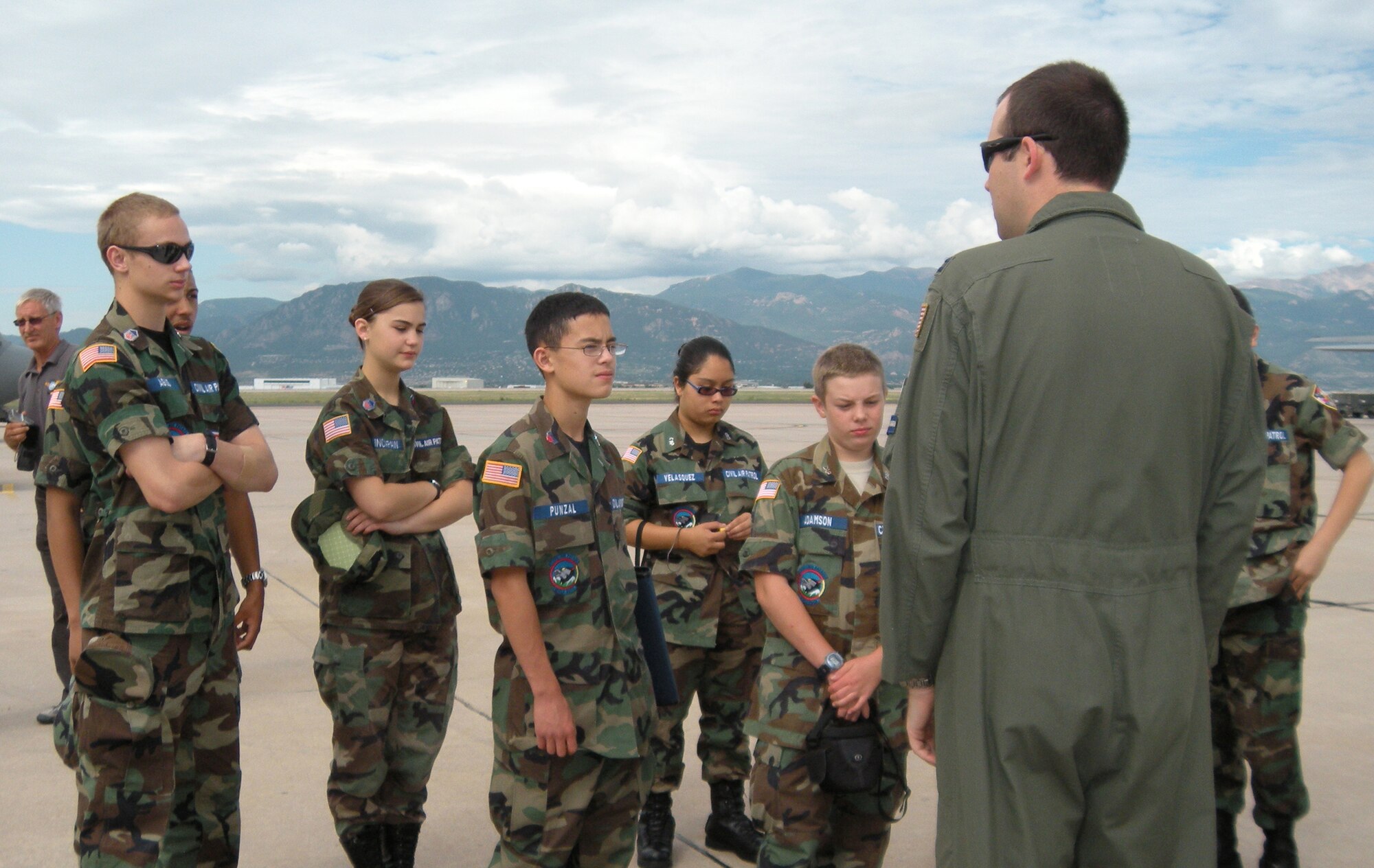 Capt. Chris Rothe, an Air Force Reserve C-130 Hercules pilot, briefs Colorado Civil Air Patrol cadets on the specifications of the aircraft July 30 during a CAP and International Air Cadet Exchange program tour at Peterson Air Force Base, Colo. More than 30 cadets from Colorado as well as Great Britian, Belgium and Turkey visited the Air Force Reserve's 302nd Airlift Wing to gain a better perspective on military aeronautics as well as see the wing's aircrew life support element. Captain Rothe, a former CAP cadet, is assigned to the wing's 731st Airlift Squadron. (U.S. Air Force photo/Rebekah Williamson)