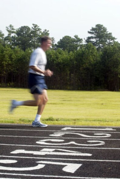 Runners took part in a ribbon cutting ceremony marking the official opening of the Dobbins Air Reserve Base running track Aug 6. (U.S. Air Force Photo/Don Peek).