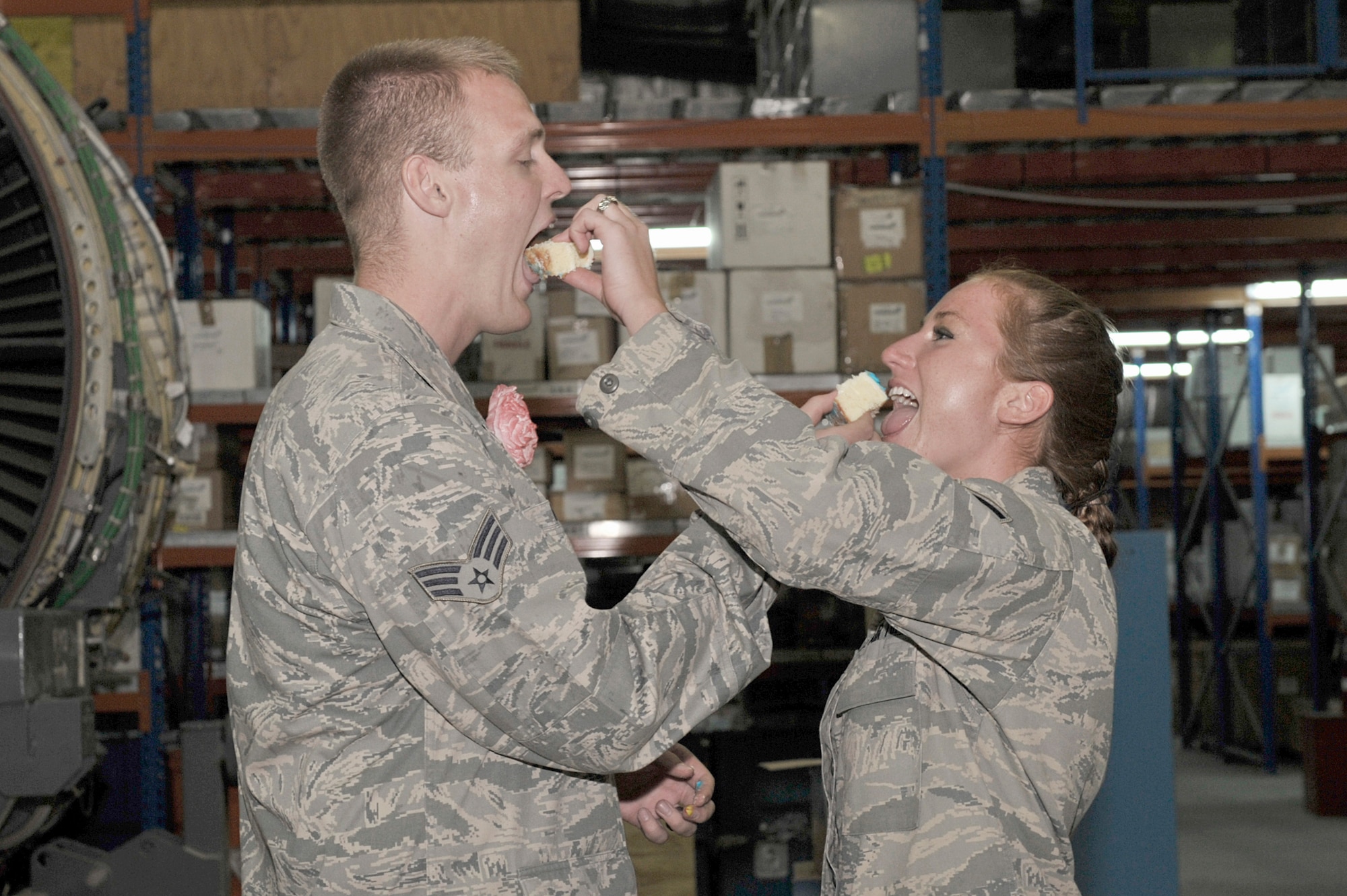 Senior Airman Donald Nolen and Senior Airman Sheri Nolen feed each other wedding cake after their wedding ceremony Aug 4, 2010, at an air base in Southwest Asia. The Nolens are members of the 380th Expeditionary Aircraft Maintenance Squadron. They were married by proxy on July 12, 2010, through the state of Montana. (U.S. Air Force photo/Tech. Sgt April Wickes)