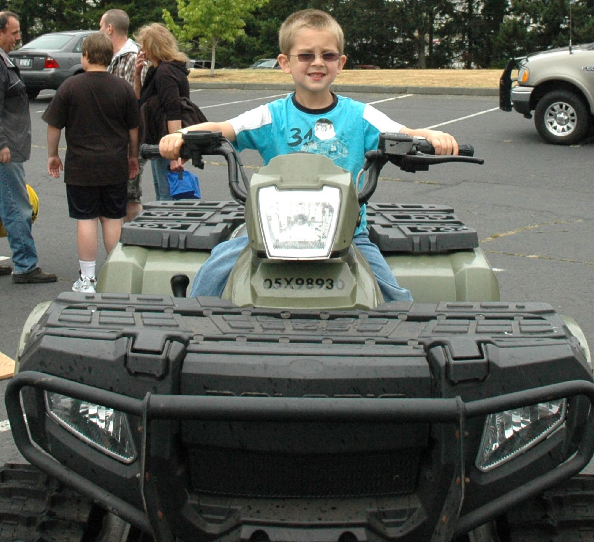 JOINT BASE LEWIS-MCCHORD, Wash., - Christian Hillman, 5, revs up a Polaris ATV at the 446th Airlift Wing Family Day on Aug. 7 here.  Christian is the grandson of Master Sgt. Melissa Sorensen, a logistical support manager assigned to the 446th Logistics Readiness Flight. (U.S. Air Force photo/Staff Sgt. Elizabeth Moody)