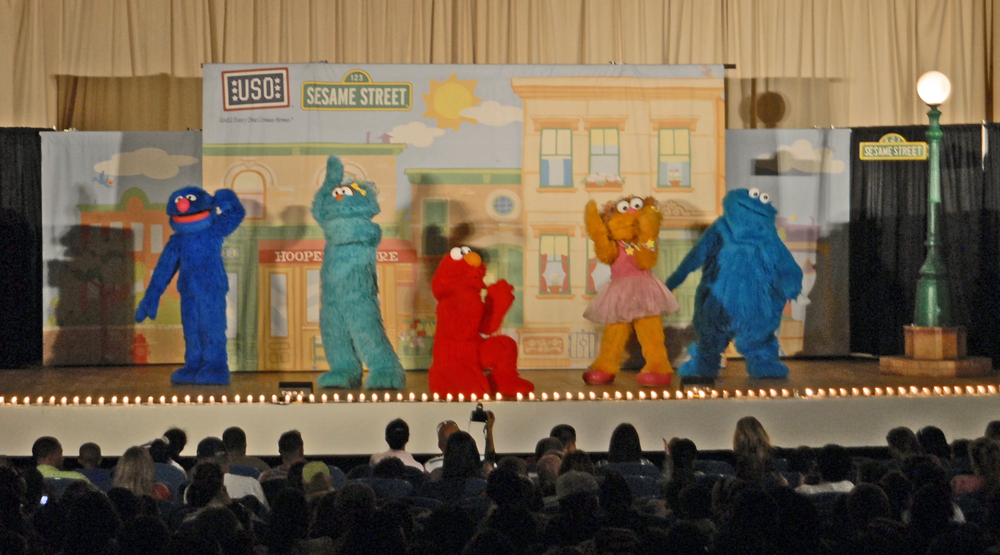 Characters from the Sesame Street/USO Experience for Military Families, a free traveling USO show, perform for Peterson Air Force Base military families July 31 at the base auditorium. The tour is more than half way through its five-month summer leg and will have visited 105 bases around the world when it wraps up in September 2010. (U.S. Air Force Photo/Airman 1st class Jessica Hines)