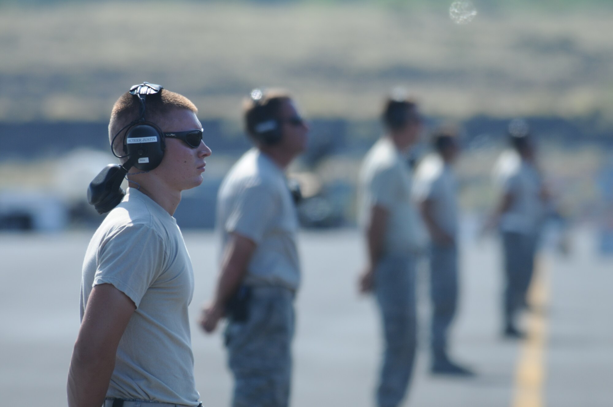 Airman First Class Justin McTeer, a crew chief for the 144th Fighter Wing, Fresno, Calif., waits to marshall out his F-16C Fighting Falcon in support of the Rim of the Pacific exercise on July 15, 2010 at the Kona International Airport, Hawaii.  RIMPAC is a biennial exercise that promotes interoperability involving people and assets from 14 different nations.  (U.S. Air Force photo by Senior Master Sgt. Chris Drudge/released)