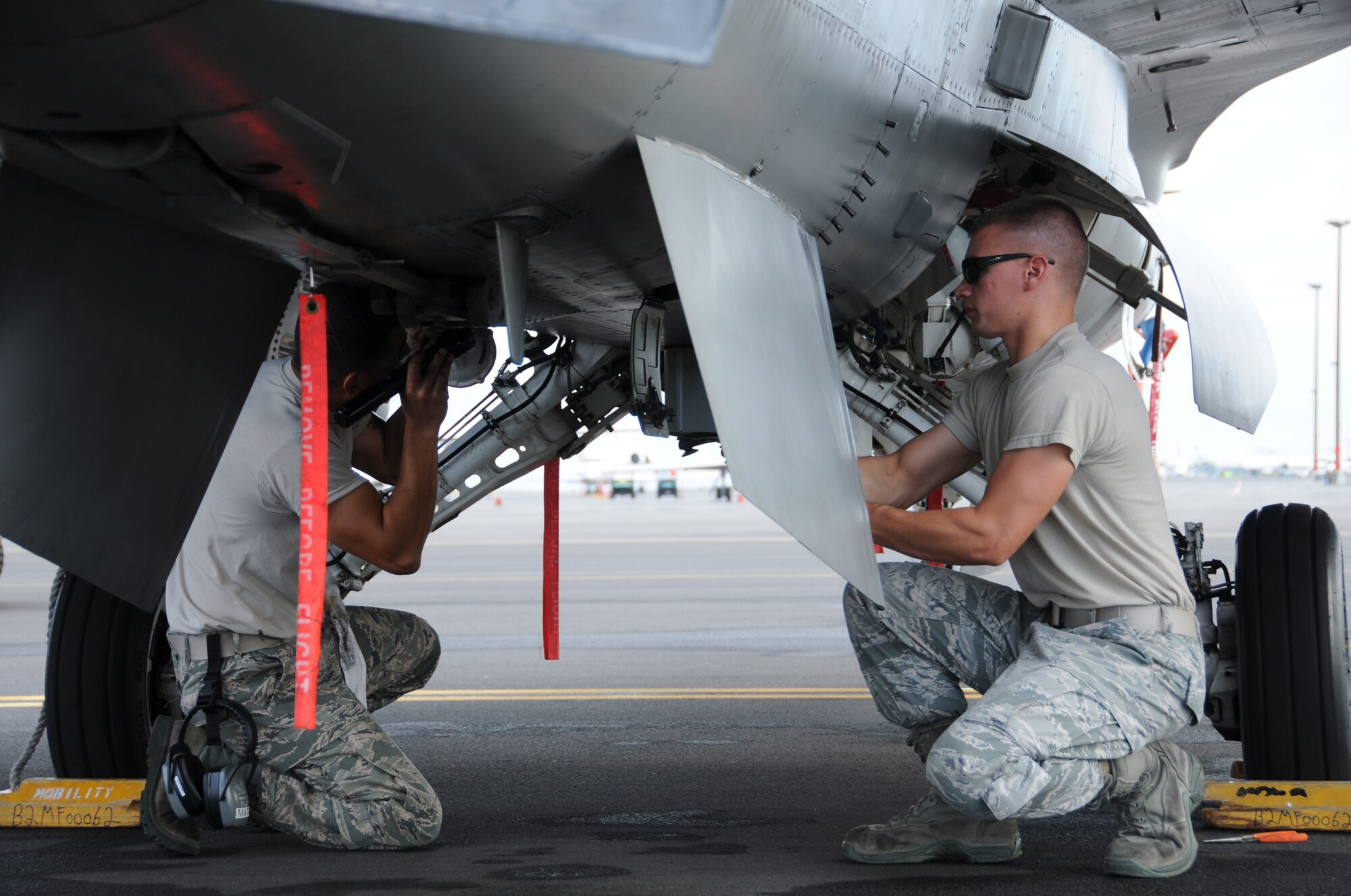 Staff Sergeant Jesus Mata, a 144th Fighter Wing phase maintainer, and Airman First Class Justin McTeer, a 144th Fighter Wing crew chief, complete the  post flight inspection checklist on the F-16C Fighter in support of the Rim of the Pacific exercise on July 13, 2010, Kona International Airport, Hawaii.  RIMPAC is a biennial exercise that promotes interoperability involving people and assets from 14 different nations.  (USAF photo by SMSgt Chris Drudge)(released)
