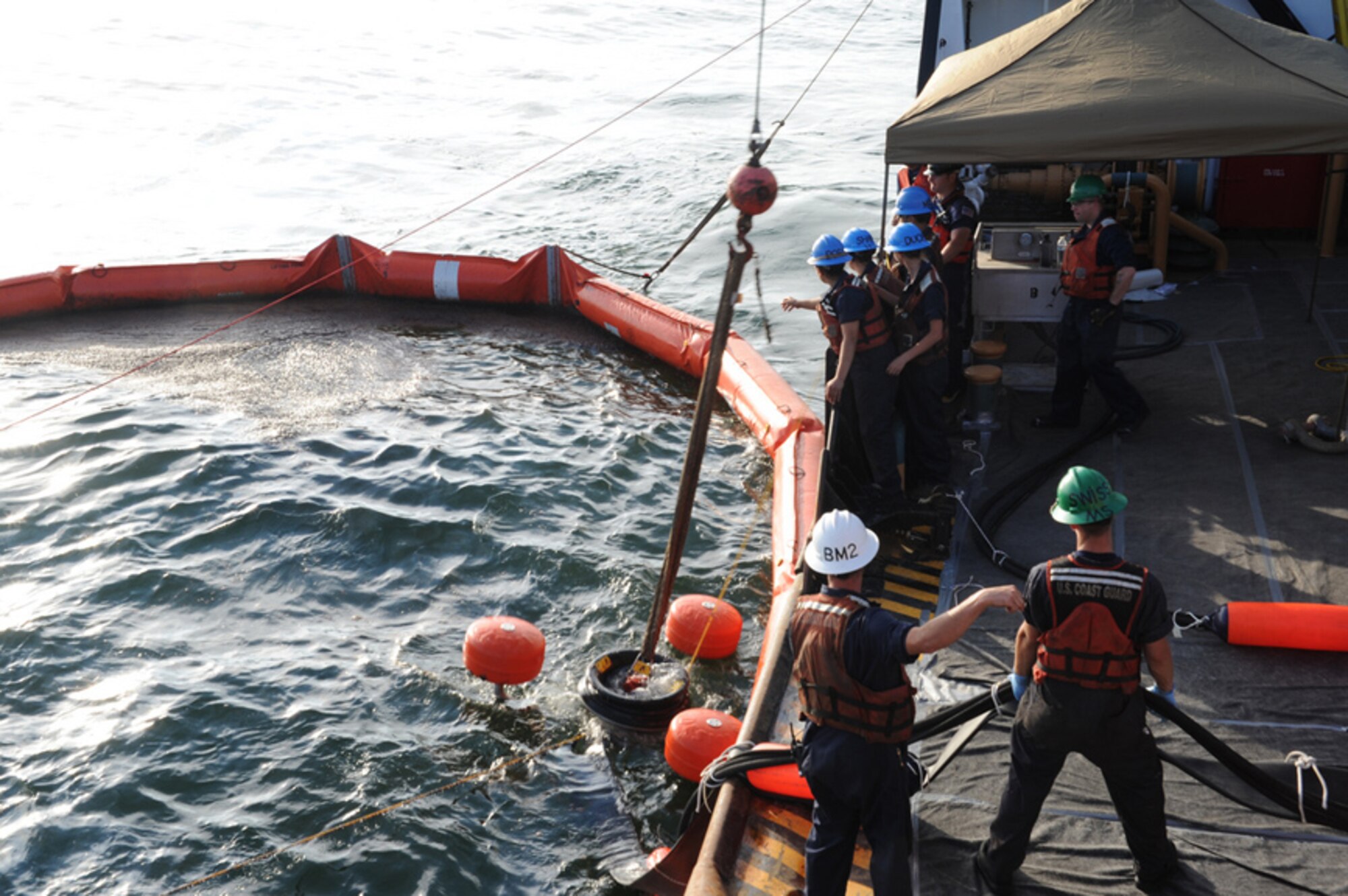 PENSACOLA, Fla. – Crewmembers aboard the Coast Guard Cutter Juniper deploy the Shipboard Oil-Recovery System (SORS) pump from the buoy deck in to the boom area where oil is collected and contained June 11, 2010. The Juniper, home-ported in Newport, R.I., began oil-skimming operations off the Fla. and Ala. coasts Friday. (U.S. Coast Guard photo by Petty Officer 3rd Class Colin White) 