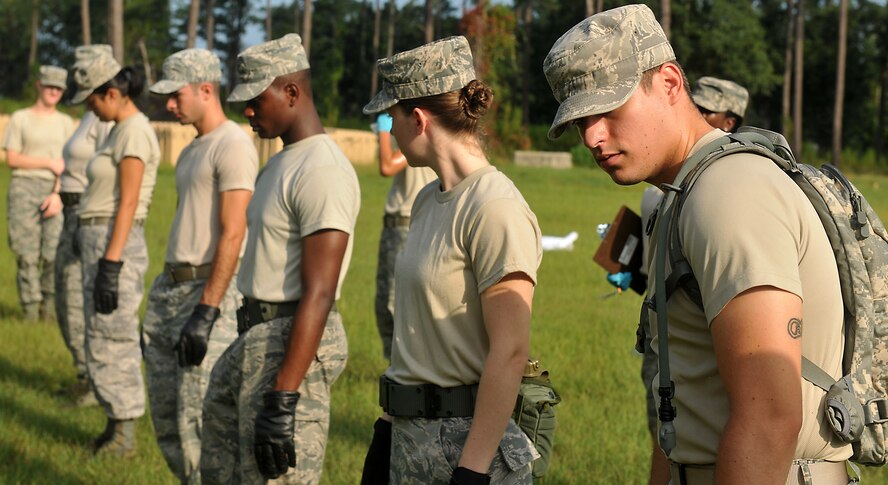 MOODY AIR FORCE BASE, Ga. -- Moody Airmen check each other to ensure everyone is in step and lined up during search and recovery team training here Aug. 6. The point of this training is to prepare these Airmen to perform this job to the best of their ability after an aircraft crash. (U.S. Air Force photo by Airman 1st Class Joshua Green/RELEASED)
