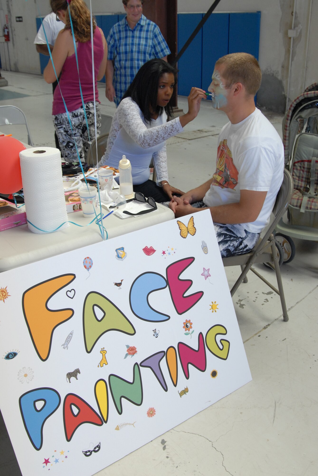 Several activities were on hand for children and adults like face-painting, fun identification badges and ice cream making at AFRL family day Aug. 5.  (Air Force photo by Kenji Thuloweit)