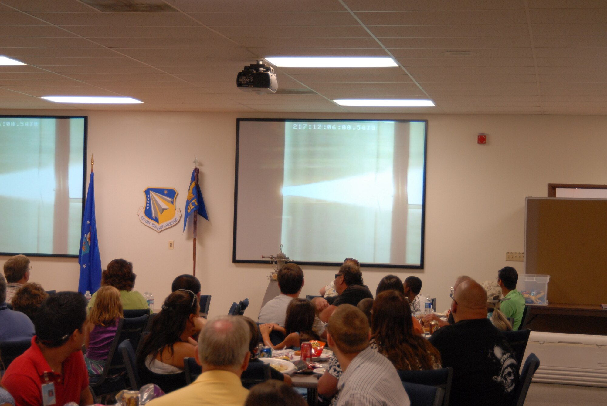 The main feature of the AFRL family day was the luncheon where family members and AFRL staff were treated to a live BATES rocket test. The Ballistic Test in an Evaluation System, which is a standard procedure to test a rocket propellant in a motor casing, burned 15-pounds of propellant in a custom made rocket engine in about five seconds. The BATES test was one in a series and was scheduled specifically for the AFRL family day so spouses and children could see what the AFRL is all about. After lunch, family members broke down into three groups to go on tours of different AFRL facilities, Aug. 5. (Air Force photo by Kenji Thuloweit)  
