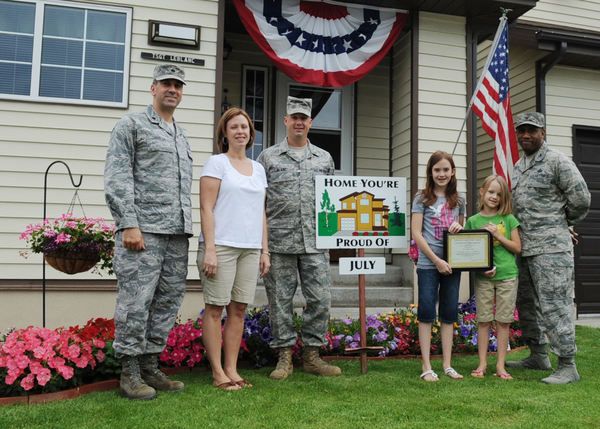 Tech. Sgt. Christopher Leblanc and family display their "Home You're Proud Of" award with 354th Civil Engineer Squadron commander Lt. Col. Michael Sheredy and 354th Mission Support Group commander Col. Karlton D. Johnson August 5, Eielson Air Force Base, Alaska. Each winning household recieves gift cards from various units on base and businesses off base. Sergeant Leblanc is assigned to the 354th Civil Engineer Squadron. (U.S. Air Force photo/Airman 1st Class Laura Goodgame)