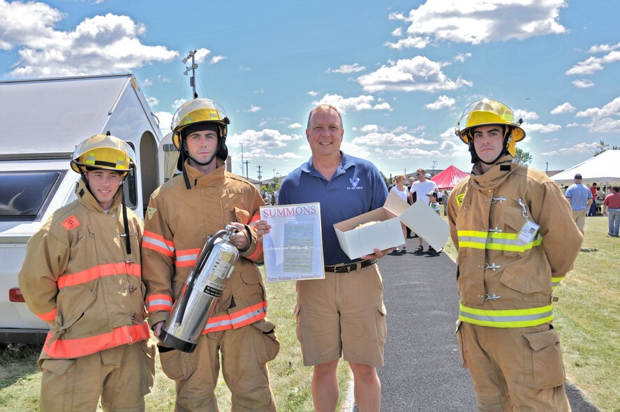914th Airlift Wing Commander Col. Allan L. Swartzmiller receives his birthday cake from the Niagara Falls Air Reserve Station Fire Department during the annual 914th Airlift Wing Family Day, August 7, 2010, Niagara Falls Air Reserve Station NY. As an attempt at humor, the Niagara Falls Air Reserve Station Fire Department provided Swartzmiller, 50, with a burn permit due to the “large amount” of candles for the cake. (U.S. Air Force photo by Staff Sgt. Joseph McKee)
