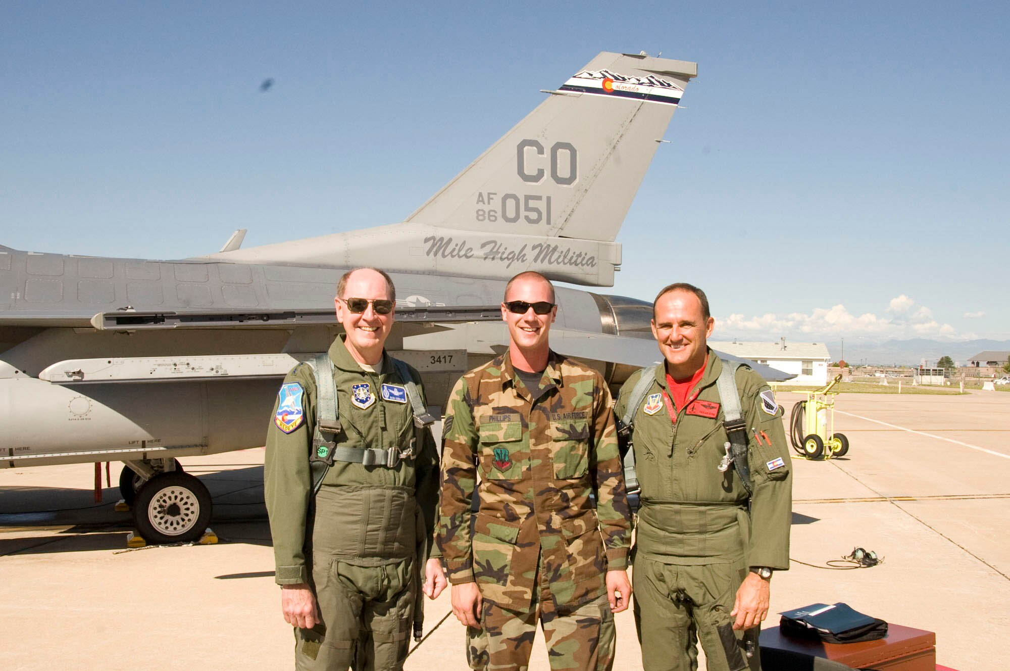 BUCKLEY AIR FORCE BASE, Colo. -- Gen. C. Robert Kehler, Air Force Space Command commander (left), poses with Brig. Gen. Trulan Eyre, 140th Wing commander (right), and Staff Sgt. Jared Phillips, 140th Maintenance Group (center), in front of a Colorado Air National Guard F-16 Fighting Falcon Aug. 6. (U.S. Air Force photo)