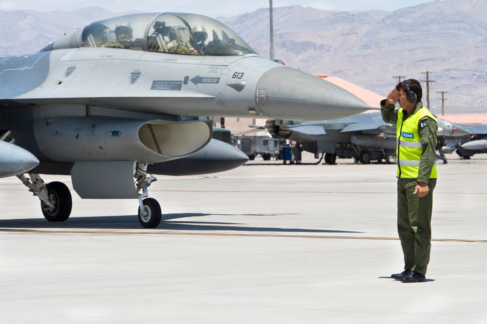 NELLIS AIR FORCE BASE, Nev.-- A Pakistan Air Force crew chief renders a salute to his F-16 and air crew members prior to take off during Red Flag 10-4 at Nellis on July 29, 2010.  Approximately 100 maintenance, support and aircrew personnel arrived here in mid-July to participate in the intense two-week Red Flag exercise, which concentrates on large force combat employment. (U.S. Air Force Photo by Lawrence Crespo)