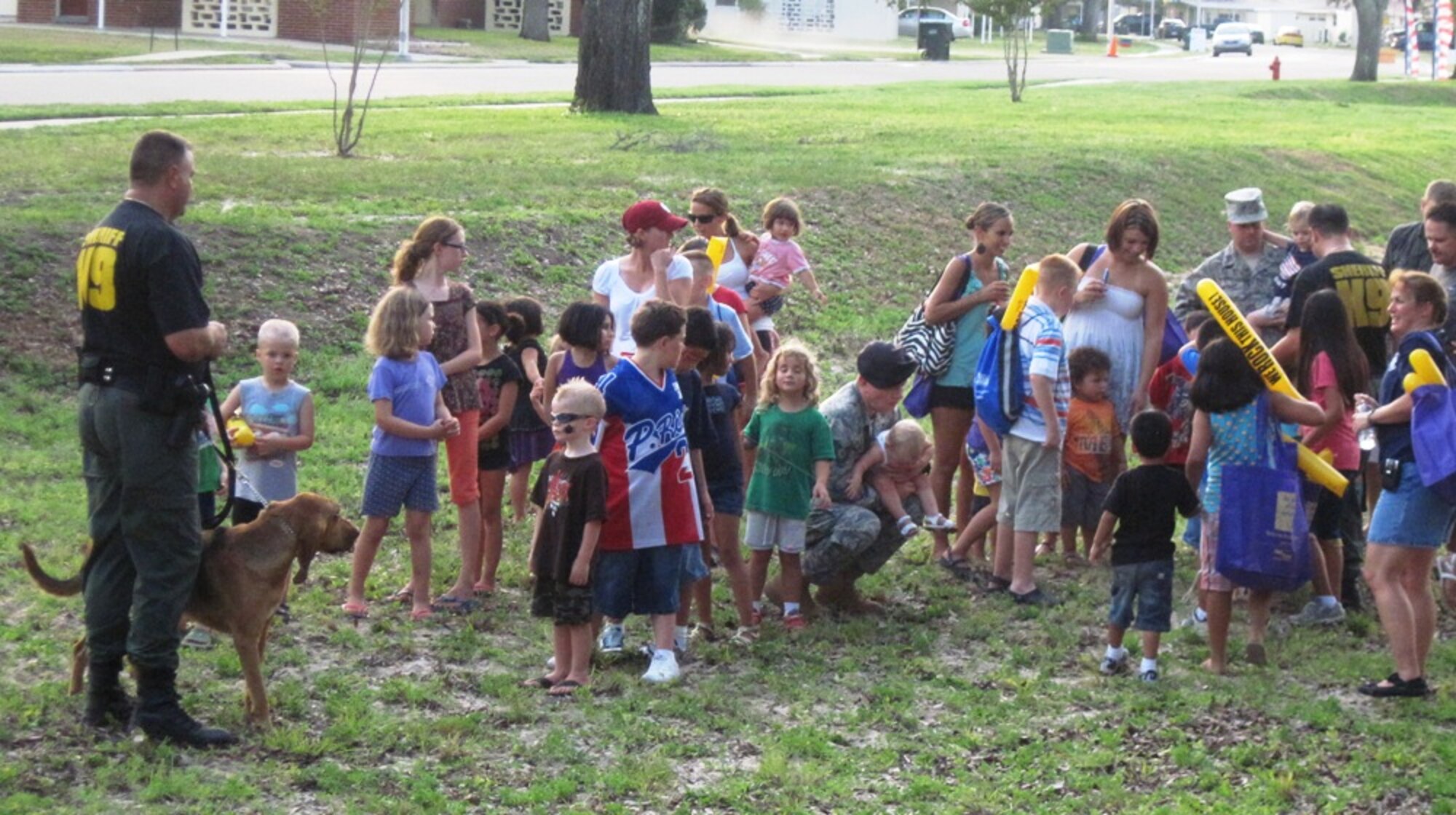 Lt. Kevin Francis and Sgt. Adam Buff with K-9, "Durka," from the Bay County Sheriff's Department, visit with children during a demonstration at the National Night Out block party Aug. 3 on Tyndall. The 27th Annual National Night Out is a unique crime and drug prevention event organized for Tyndall by Samantha Hilton, resident specialist and Lifeworks coordinator for Balfour Beatty Communities. The event secured sponsors and participation from all of the base members, Balfour Beatty Communities team, and local authorities who came out and donated all of the games, activities, safety demonstrations and food. (Photo by Samantha Hilton)