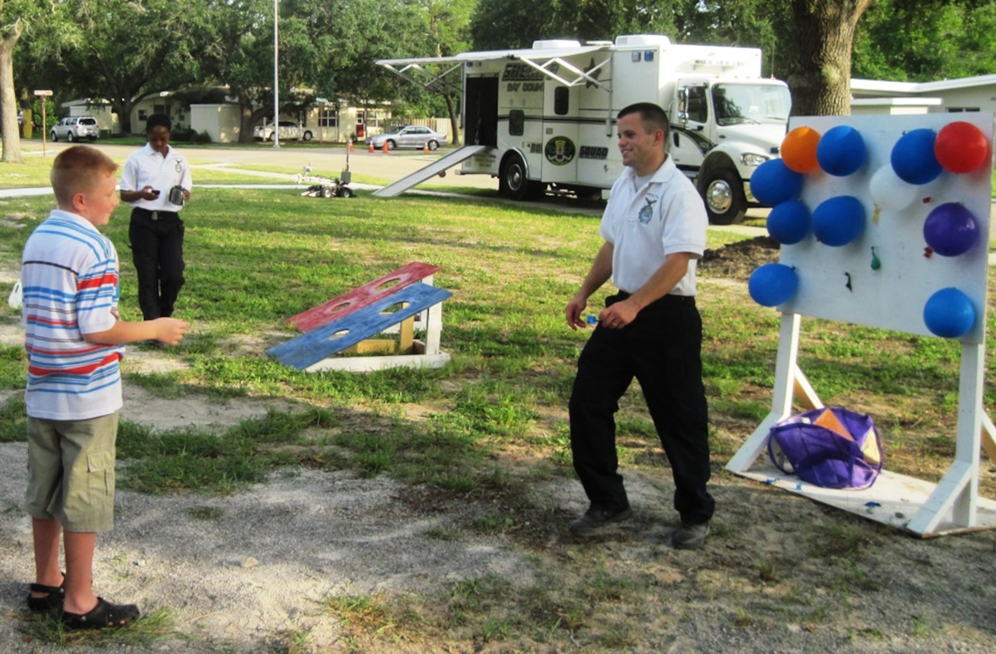 Airman 1st Class Robert Hansen, 325th Security Forces Squadron, mans the dart board as part of community police games during the National Night Out block party Aug. 3 on Tyndall. The 27th Annual National Night Out is a unique crime and drug prevention event organized for Tyndall by Samantha Hilton, resident specialist and Lifeworks coordinator for Balfour Beatty Communities. The event secured sponsors and participation from all of the base members, Balfour Beatty Communities team, and local authorities who came out and donated all of the games, activities, safety demonstrations and food. (Photo by Samantha Hilton)