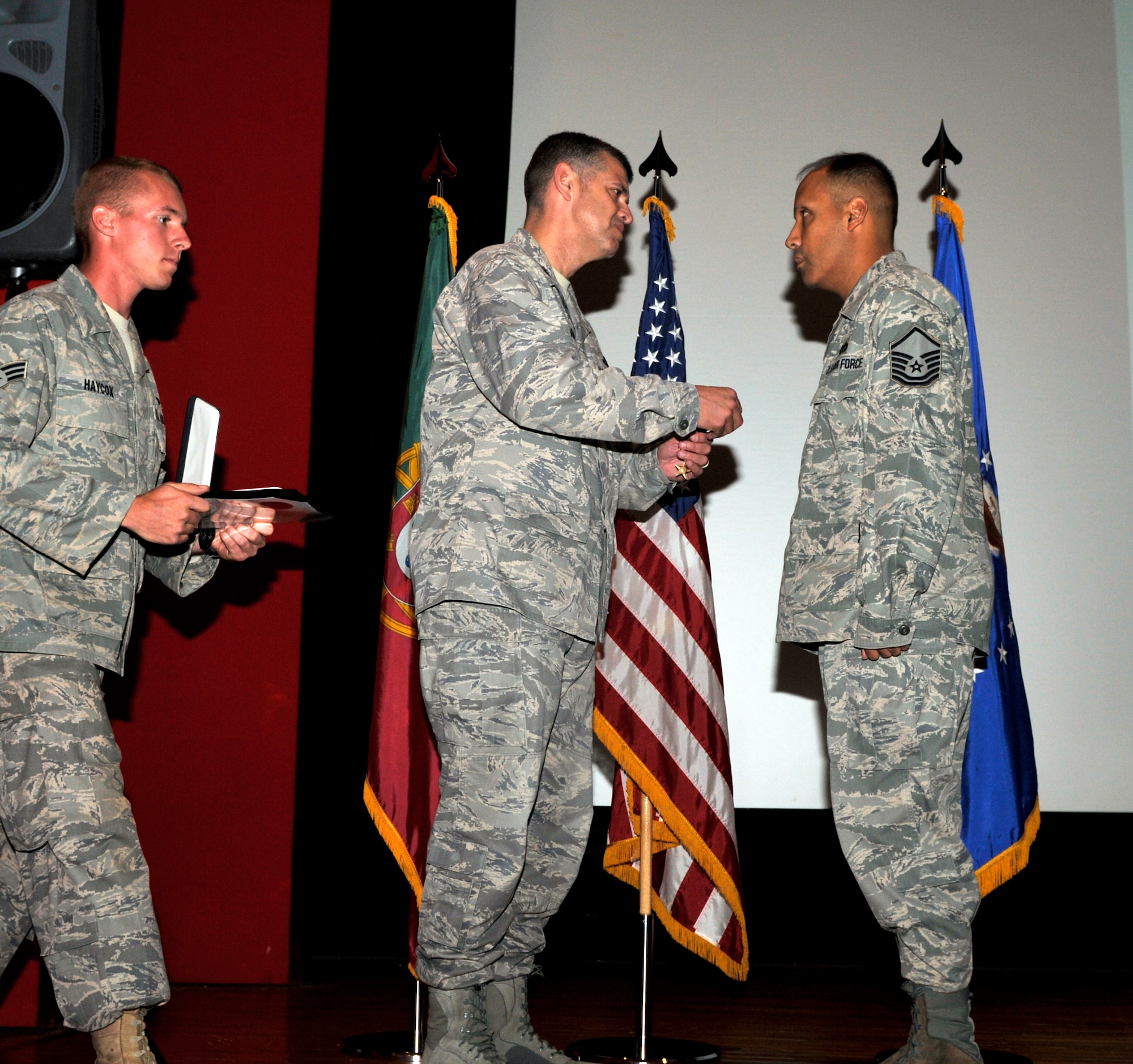 Col. Jose Rivera, 65th Air Base Wing commander, affixes the Bronze Star Medal to Master Sgt. Rigoberto Chacon’s pocket flap during a ceremony here Aug. 6. Sergeant Chacon, , 65th Civil Engineer Squadron, earned the medal during his deployment to Afghanistan, where he led his teams to 40 forward operating bases and bedded down over 40,000 combat forces.  (U.S. Air Force photo/Staff Sgt. Olufemi Owolabi)   