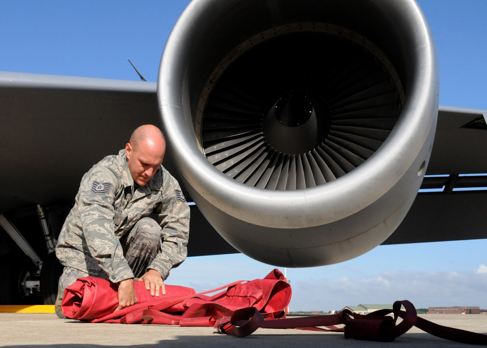RAF MILDENHALL, England – Tech. Sgt. Adam Hagar, 100th Aircraft Maintenance Squadron crew chief, rolls up intake covers of a KC-135 engine during prelaunch preparations in support of Allied Strike Aug. 5. Allied Strike is Europe’s premier annual close air support exercise that helps build partnership capacity among allied NATO nations and joint services. (U.S. Air Force photo/ Staff Sgt. Jerry Fleshman)