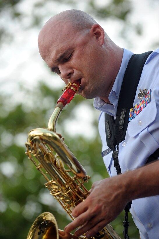 Williamsburg, Va. – Tech. Sgt. Jeffrey Saunders, Langley Air Force Base Heritage of America band, plays the saxophone at the Merchants Square during the Satellite Jazz Ensemble, Aug. 4. The band is scheduled to perform free concerts at Merchants Square in Williamsburg every Wednesday in the month of August, starting at 7pm. (U.S. Air Force photo/Senior Airman Gul Crockett)

