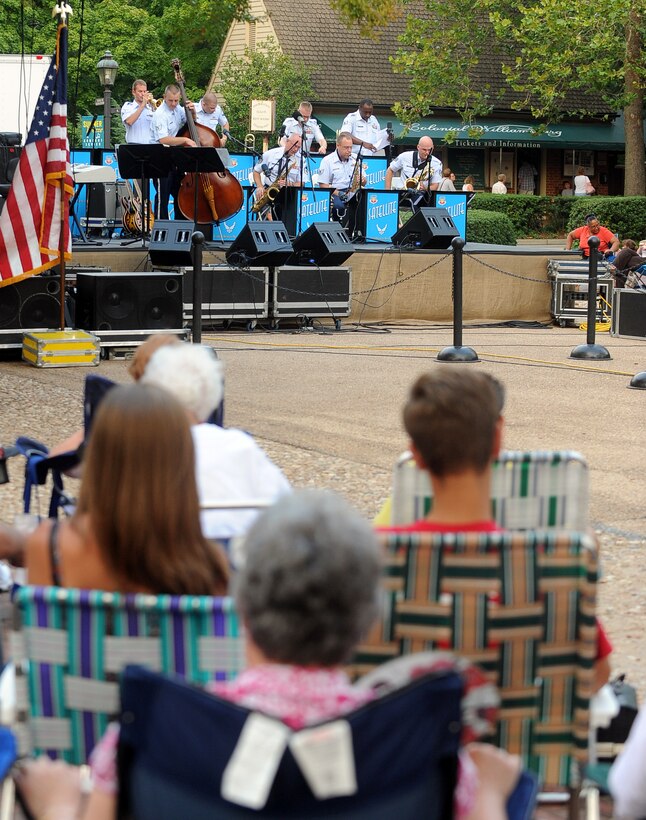 Williamsburg, Va. – Spectators watch Langley Air Force Base Heritage of America band during the Satellite Jazz Ensemble, Aug. 4. The band is scheduled to perform free concerts at the Merchants Square in Williamsburg every Wednesday in the month of August, starting at 7pm. (U.S. Air Force photo/Senior Airman Gul Crockett)